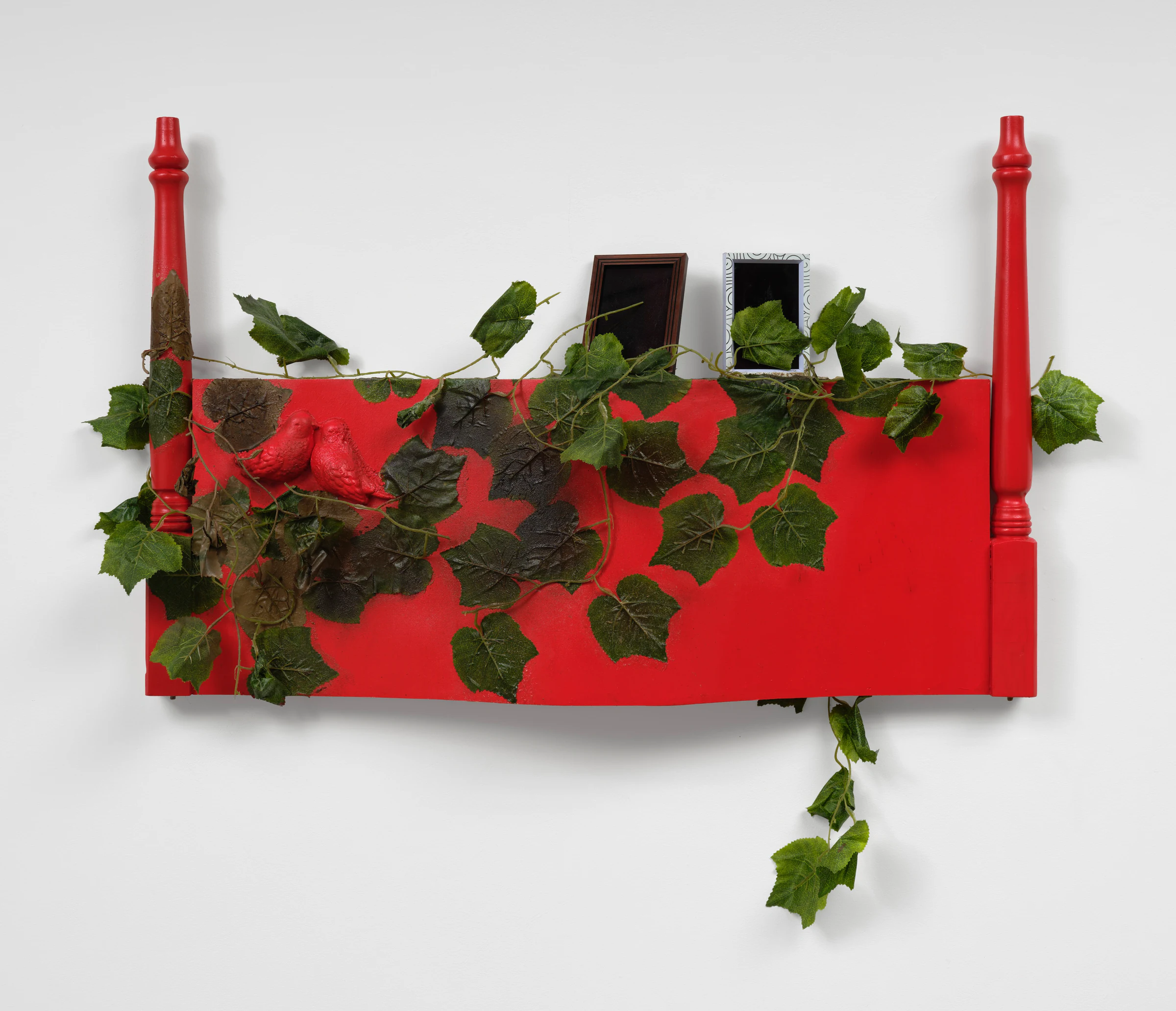 Brandon Ndife, Red Devil Cake, 2026, Wood, foam, enamel paint, photo frame, plastic, latex, 29 x 44 1/2