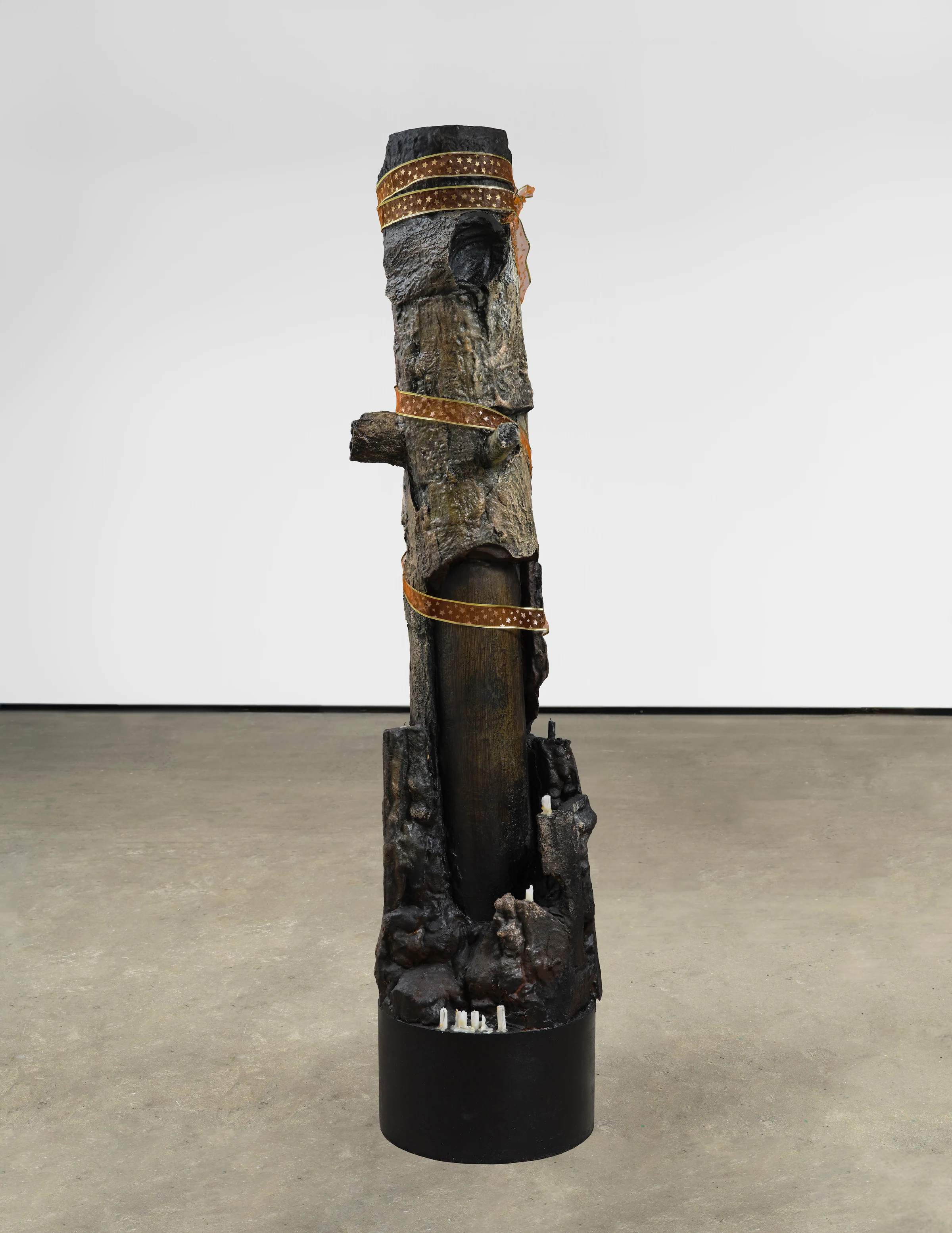 Brandon Ndife, Group Huddle (for unknown), 2026, Cardboard, foam, aqua resin, oil paint, ribbon, wax, 81 x 18 x 20 in 205.7 x 45.7 x 50.8 cm
